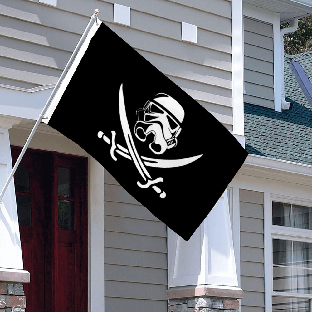 Black flag with white 501st Legion Clone Trooper helmet skull and crossed blaster rifles design hanging outside a house.