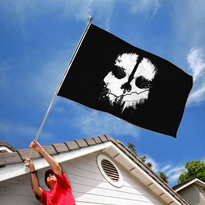 Black flag featuring a white Ghost Face mask design waving against a blue sky.
