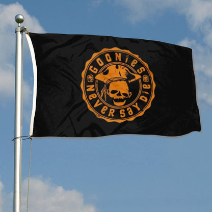 Black flag with an orange circular emblem featuring a skull and text reading "Goonies Never Say Die".