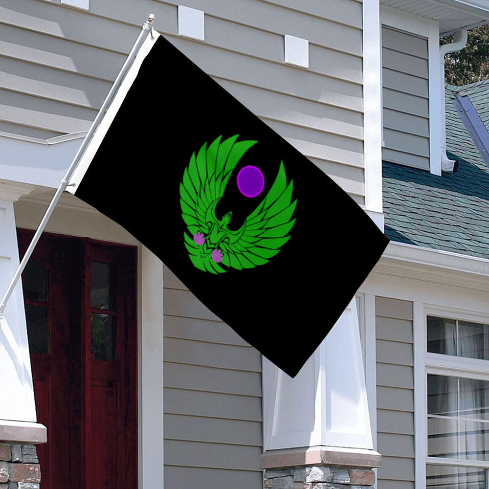 Black 3x5ft flag with green winged emblem and purple circle hanging outside gray siding house.