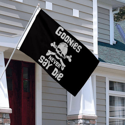 Black 3x5ft flag with white skull and crossbones and "Goonies Never Say Die" text hanging outside house.